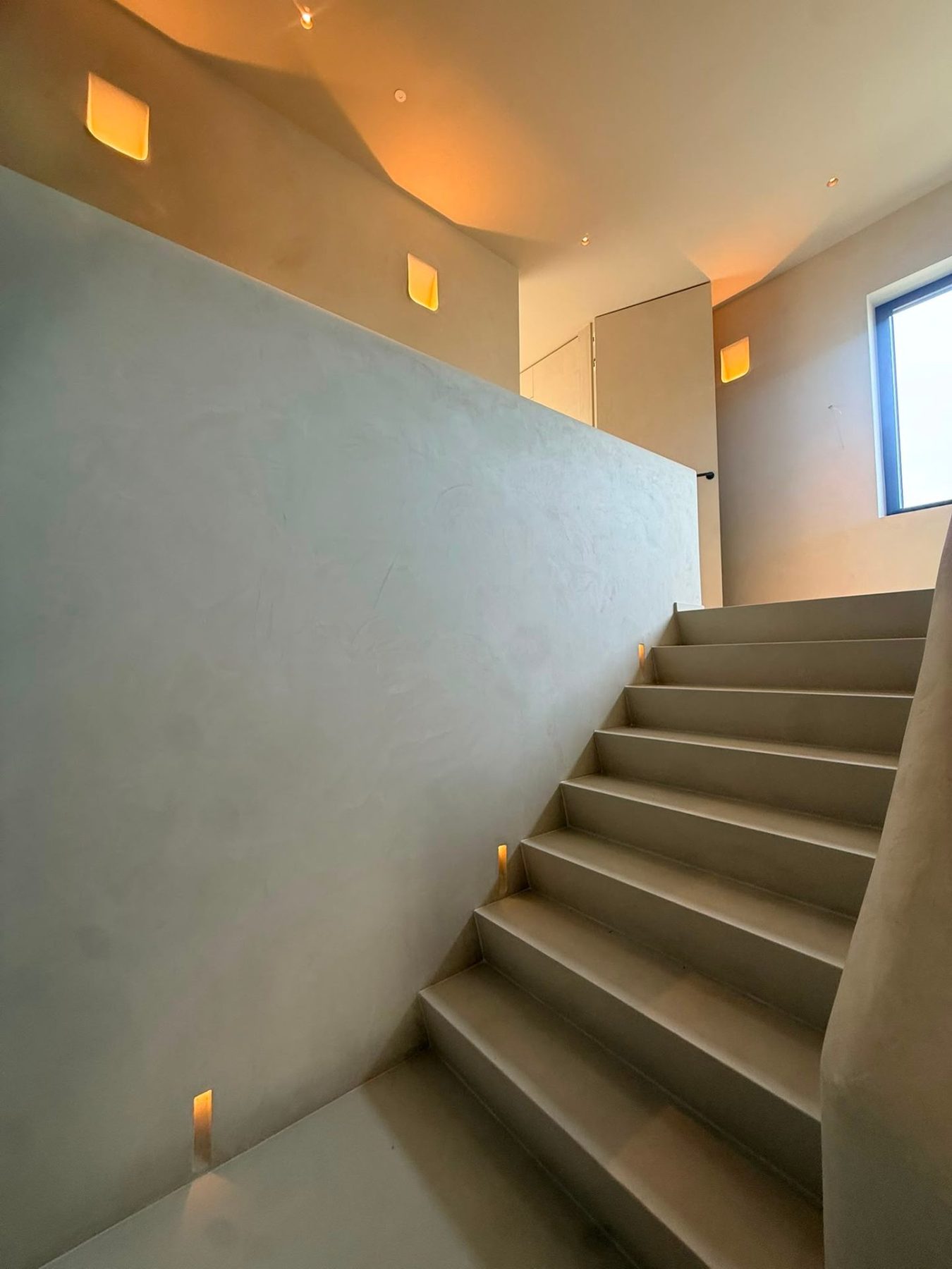 Trap in mortex met warme lichtnissen